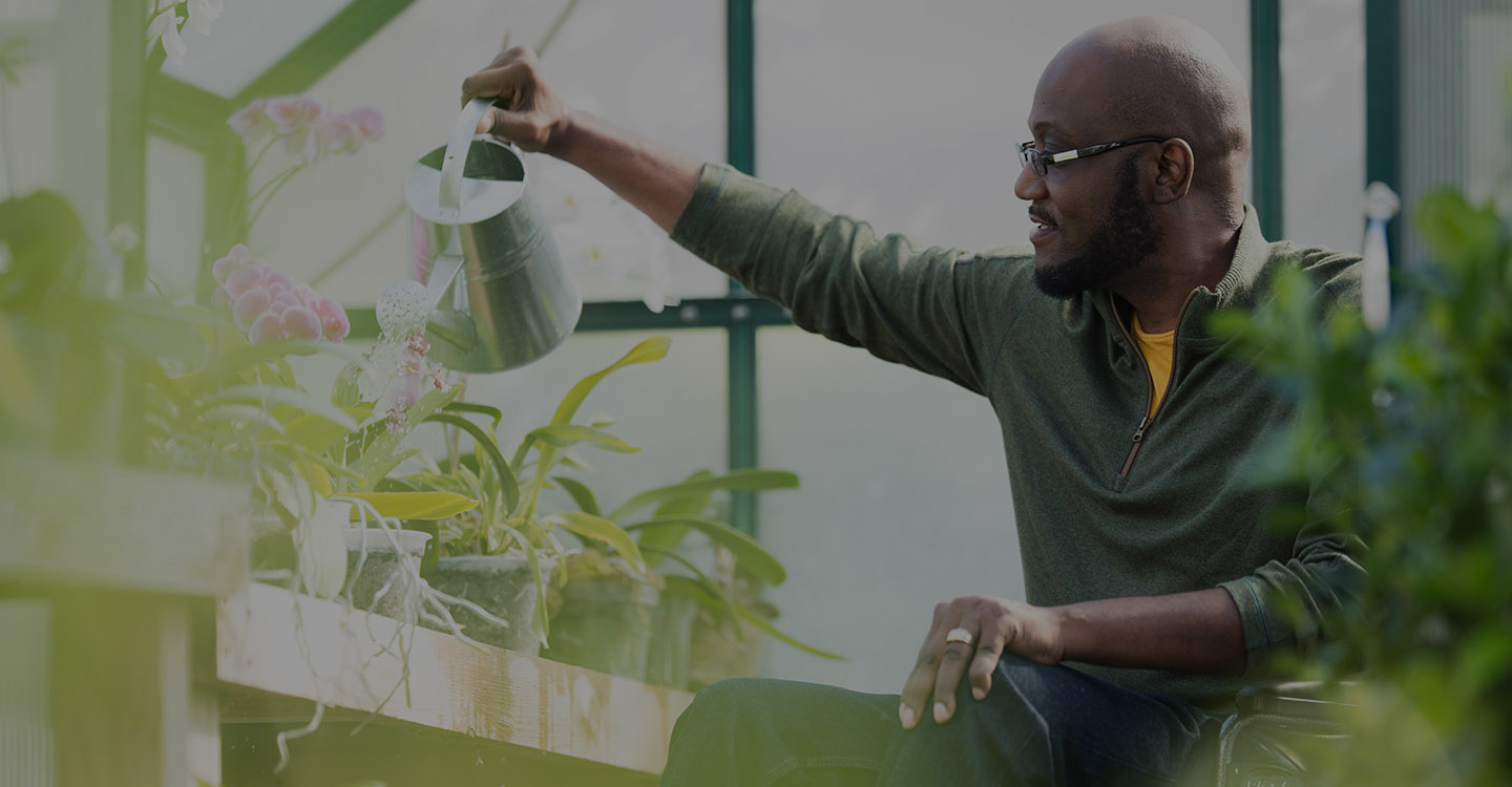 Florida man watering plants for brain health 