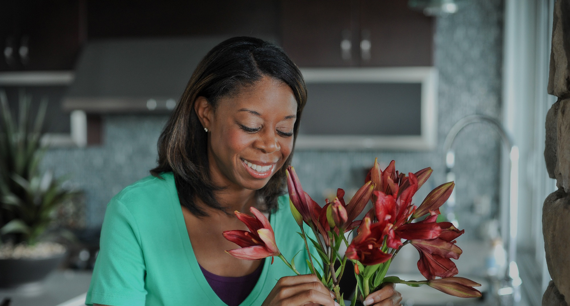 Woman arranging flowers at home.