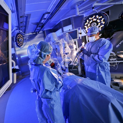 Neurologist performing a robotic assisted surgery