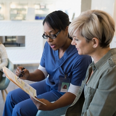 Female patient reviewing chart with female nurse