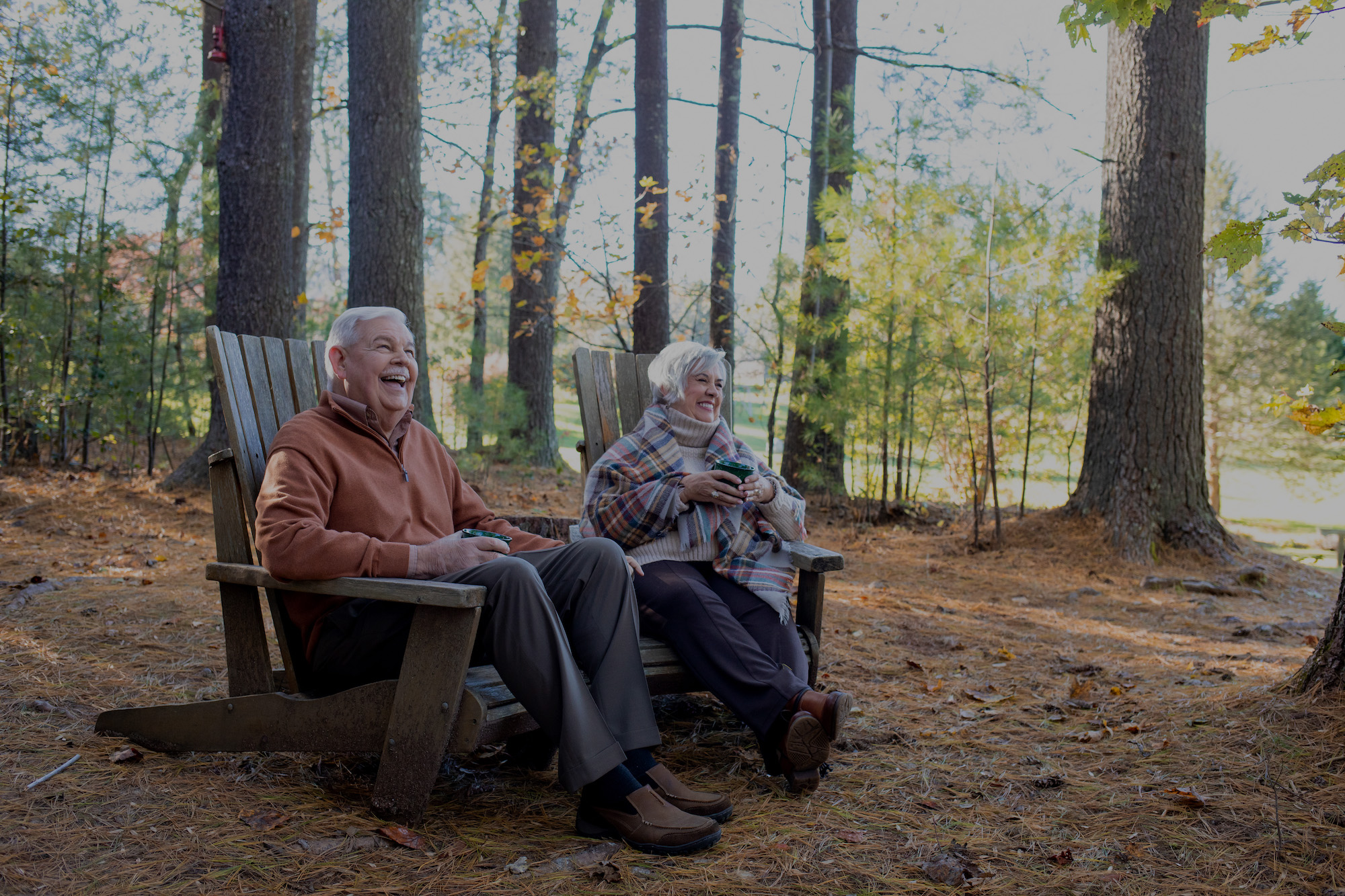 Older couple sitting outdoors in lawn chairs
