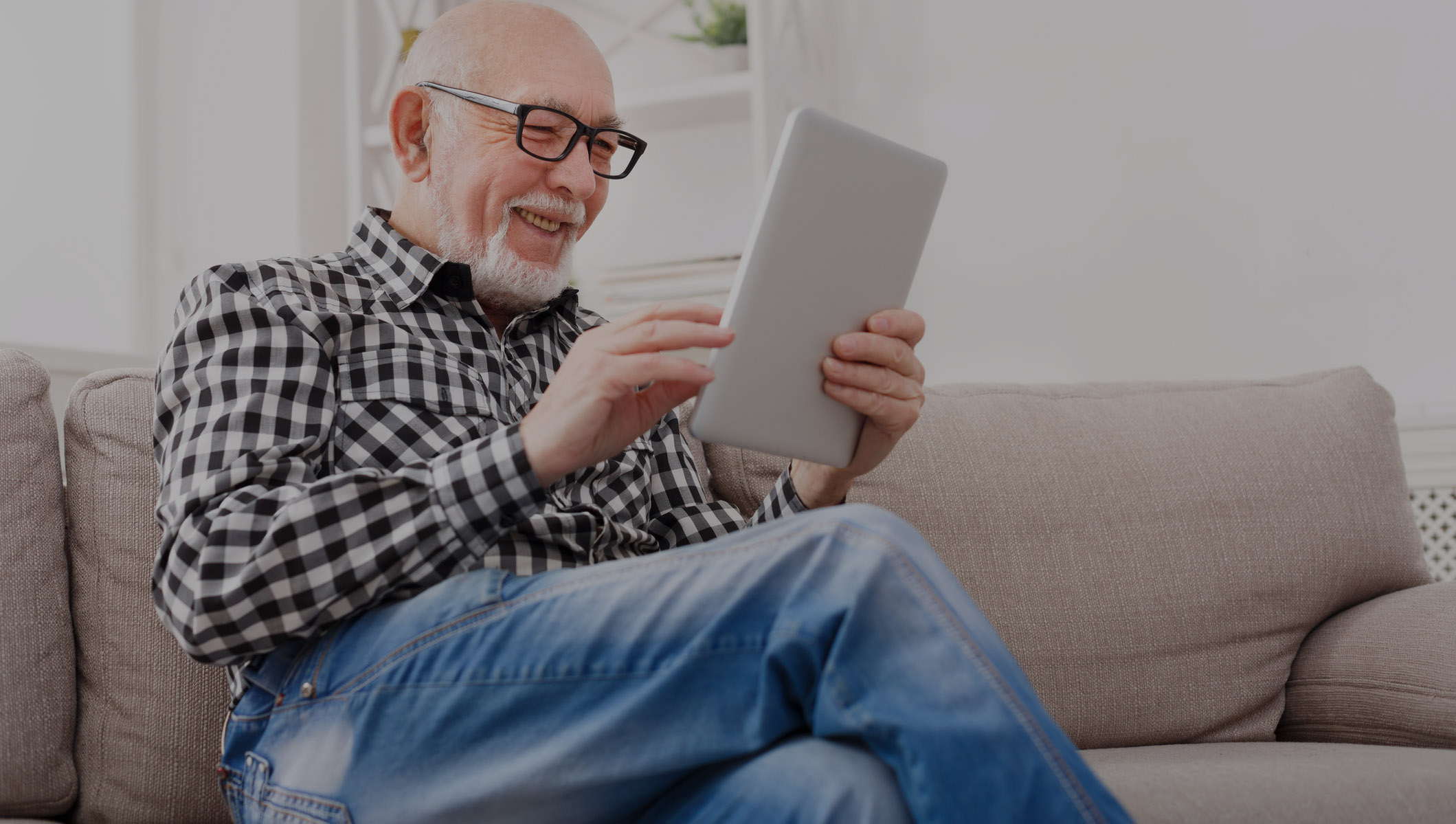 older man reading a tablet
